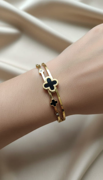 Gold double bangle with black clover motifs