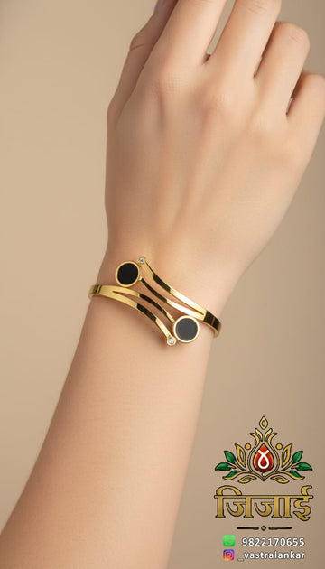 Gold double band bracelet with black circular stones