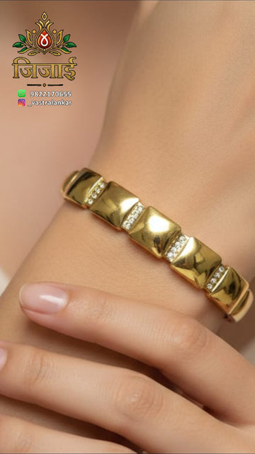 Gold segmented bangle with pave stone accents